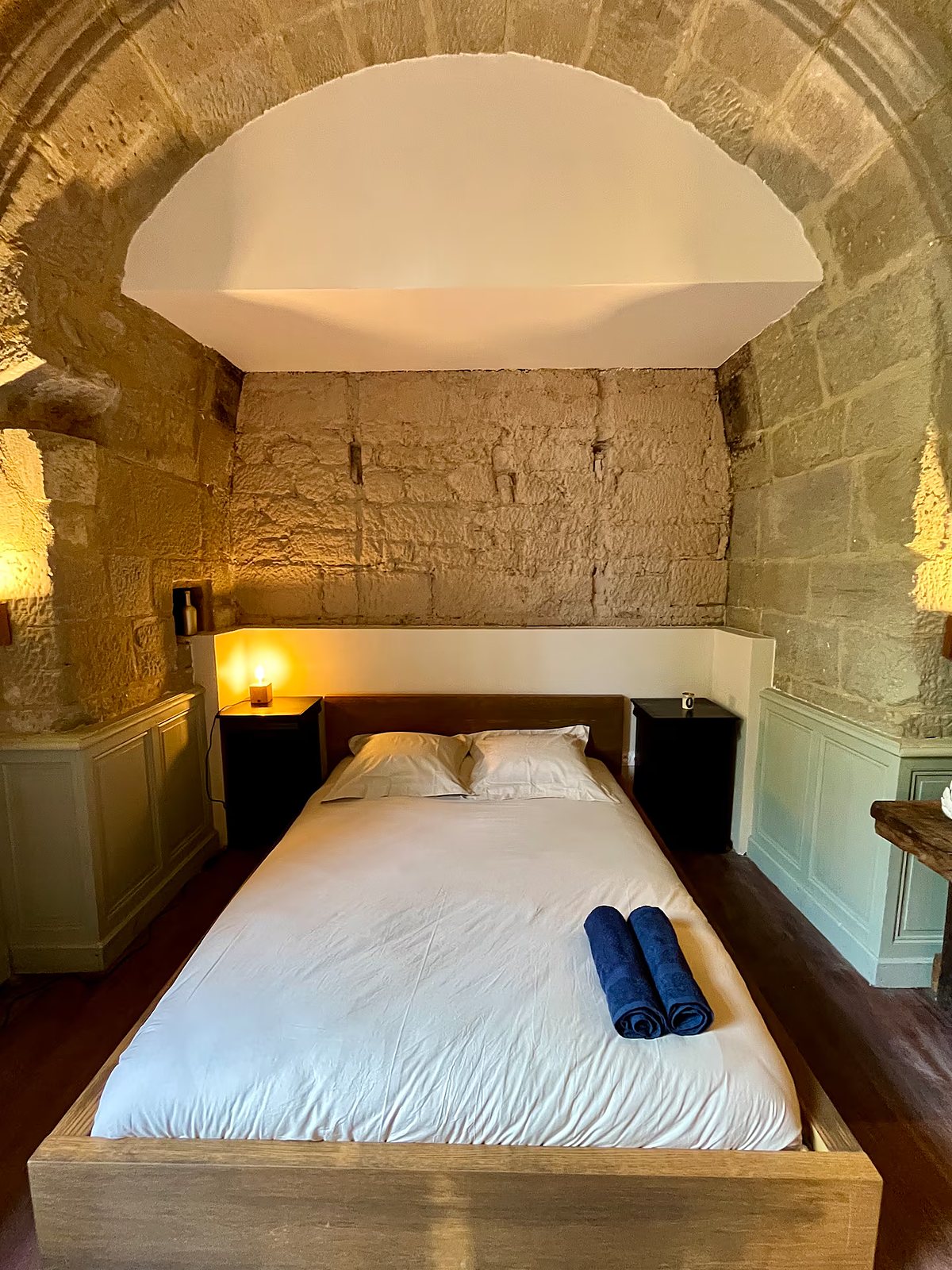 Le lit sous une arche de pierre